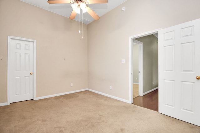 carpeted spare room with ceiling fan