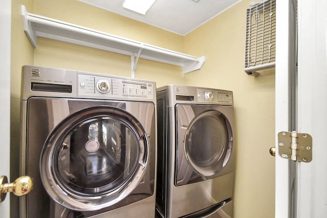 clothes washing area with washing machine and dryer