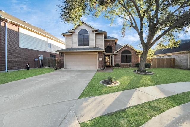 view of property featuring a front yard and a garage