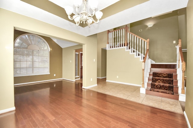 interior space with hardwood / wood-style flooring and an inviting chandelier