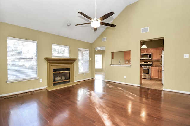 unfurnished living room with ceiling fan, light hardwood / wood-style flooring, and high vaulted ceiling