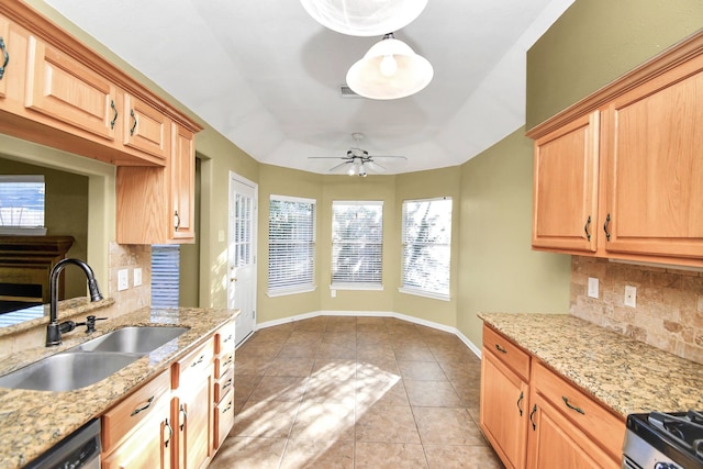 kitchen featuring ceiling fan, sink, tasteful backsplash, light tile patterned floors, and appliances with stainless steel finishes