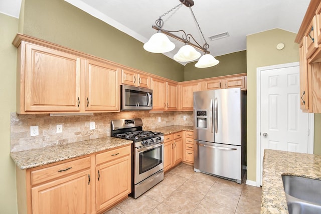 kitchen featuring decorative light fixtures, backsplash, stainless steel appliances, and light stone counters