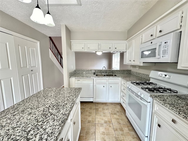 kitchen featuring sink, hanging light fixtures, a textured ceiling, white appliances, and white cabinets