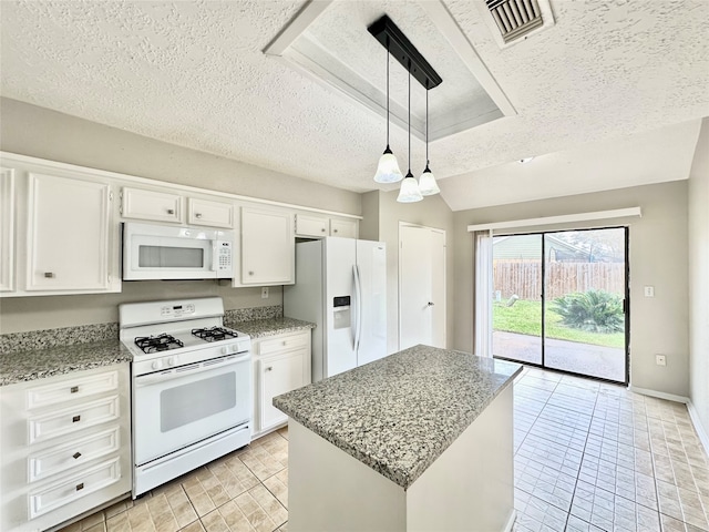 kitchen with decorative light fixtures, white cabinetry, white appliances, and a textured ceiling