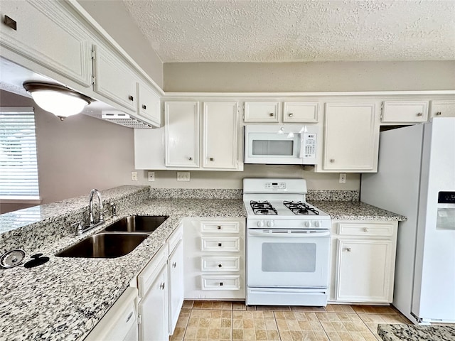 kitchen with light stone countertops, a textured ceiling, white appliances, sink, and white cabinets