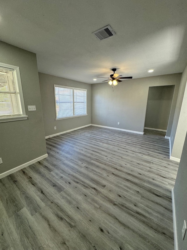 unfurnished living room with ceiling fan, a textured ceiling, and light hardwood / wood-style flooring