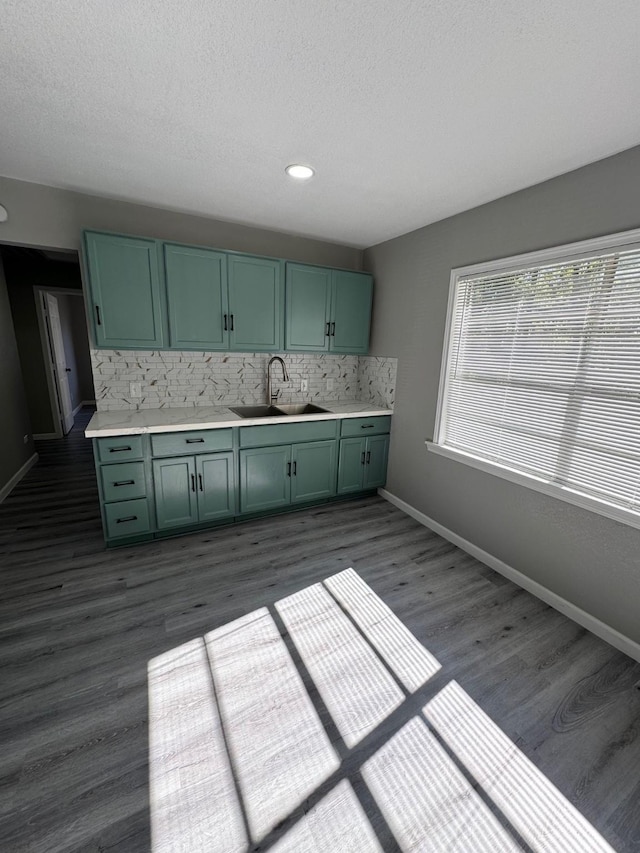 kitchen featuring sink, tasteful backsplash, dark hardwood / wood-style floors, and green cabinetry