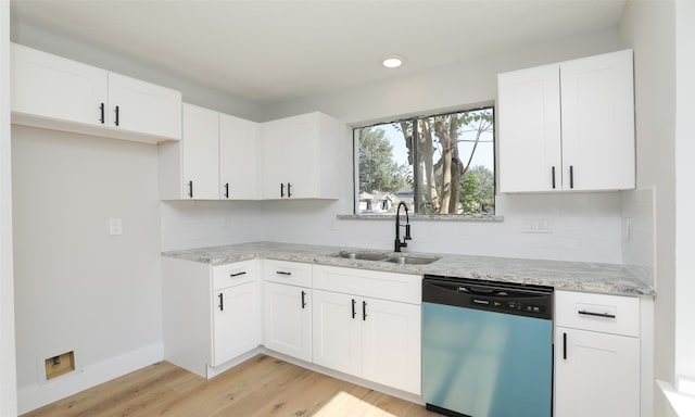 kitchen featuring white cabinets, sink, stainless steel dishwasher, light hardwood / wood-style floors, and light stone counters