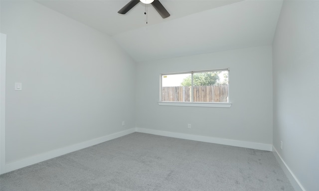 empty room with ceiling fan, light colored carpet, and lofted ceiling