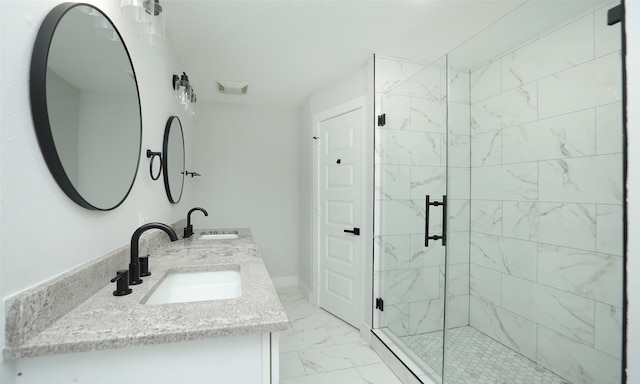 bathroom featuring a shower with door and vanity