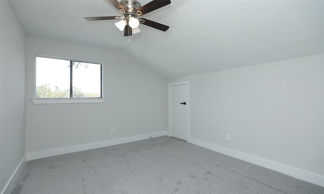 additional living space featuring ceiling fan, carpet, and lofted ceiling