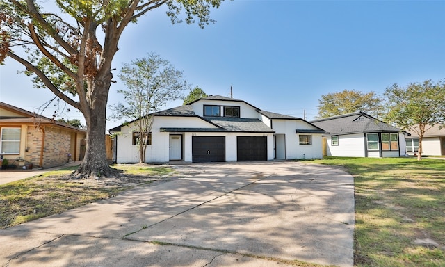 modern farmhouse featuring a front lawn and a garage