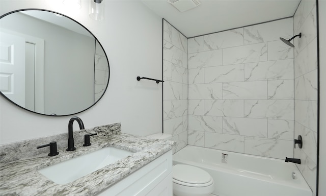 full bathroom with vanity, tiled shower / bath combo, and toilet