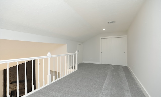 bonus room with carpet floors and vaulted ceiling