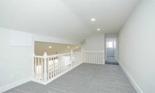 bonus room with lofted ceiling and carpet floors