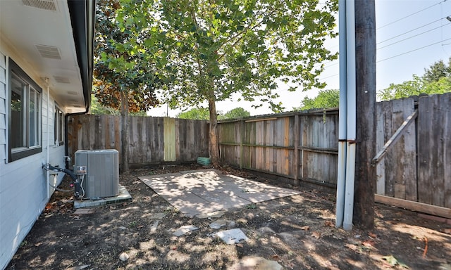 view of yard featuring a patio area and central air condition unit