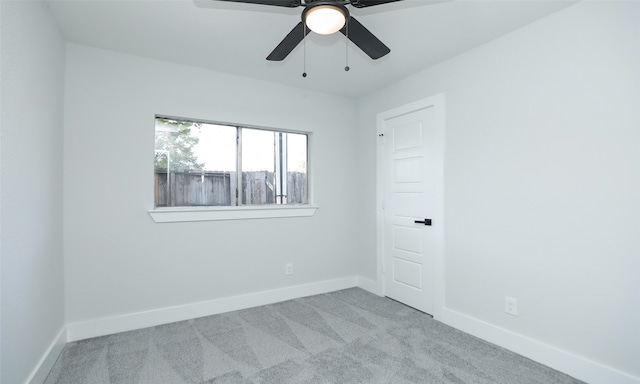 carpeted empty room featuring ceiling fan