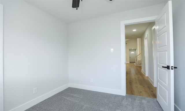 empty room with ceiling fan and hardwood / wood-style floors