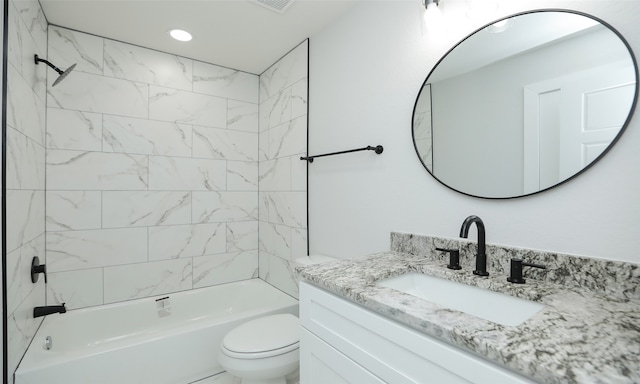 full bathroom featuring vanity, toilet, and tiled shower / bath