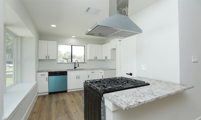 kitchen with island exhaust hood, dishwasher, white cabinets, and light hardwood / wood-style floors