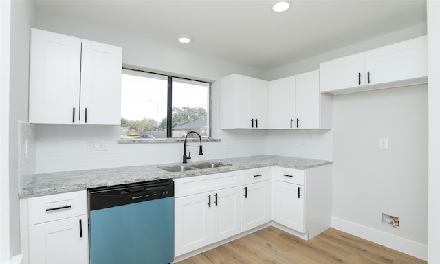 kitchen with light stone counters, sink, dishwasher, light hardwood / wood-style floors, and white cabinetry