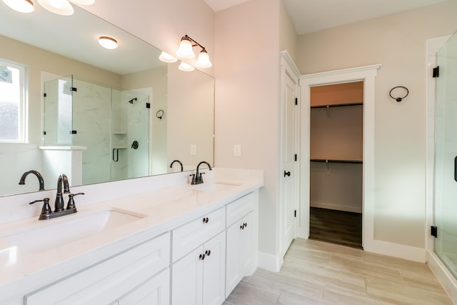 bathroom with vanity, wood-type flooring, and walk in shower