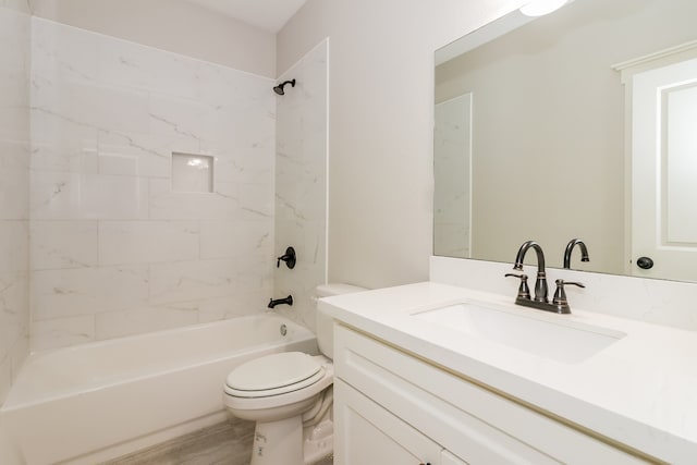 full bathroom featuring vanity, hardwood / wood-style flooring, toilet, and tiled shower / bath