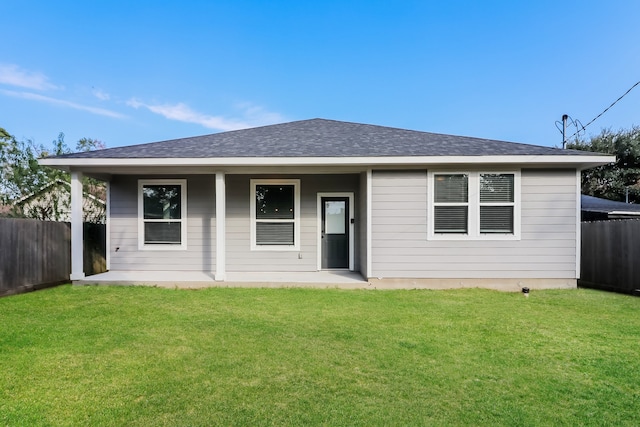 back of house featuring a lawn and a porch