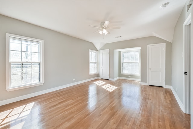 spare room with ceiling fan, plenty of natural light, and light wood-type flooring