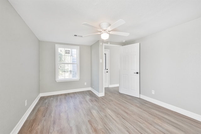 unfurnished room featuring ceiling fan and light hardwood / wood-style flooring