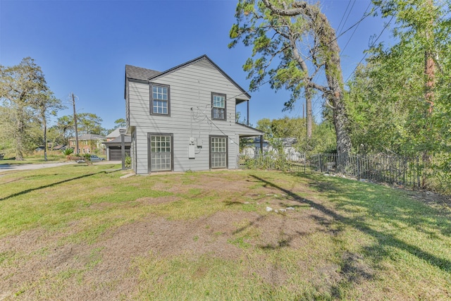 rear view of house featuring a lawn