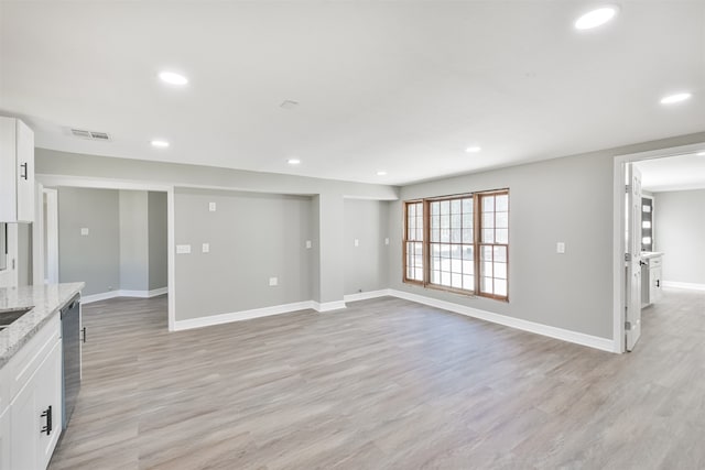 unfurnished living room with light wood-type flooring