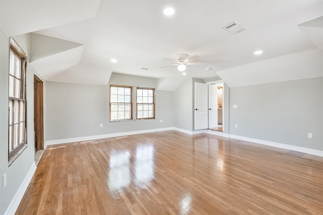 spare room with light wood-type flooring, ceiling fan, and lofted ceiling