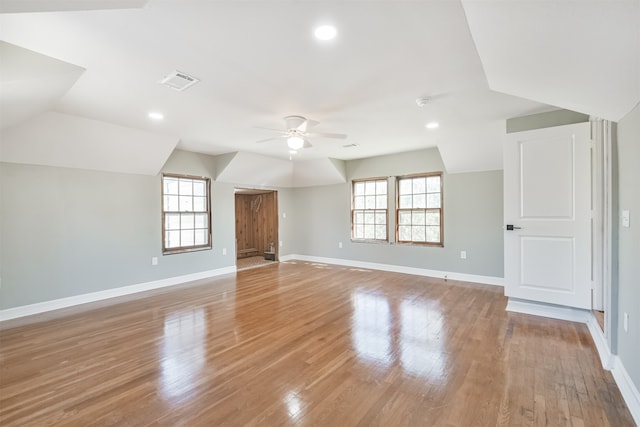 bonus room with a wealth of natural light, light hardwood / wood-style flooring, ceiling fan, and vaulted ceiling