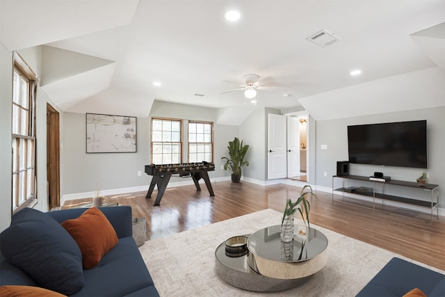 living room with light wood-type flooring, ceiling fan, and lofted ceiling