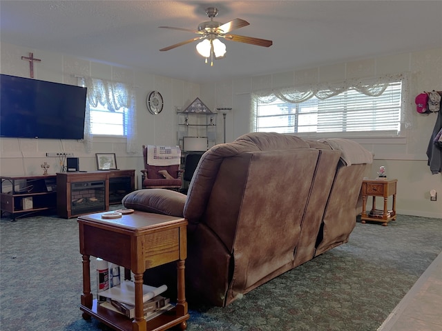 carpeted living room with ceiling fan and a healthy amount of sunlight