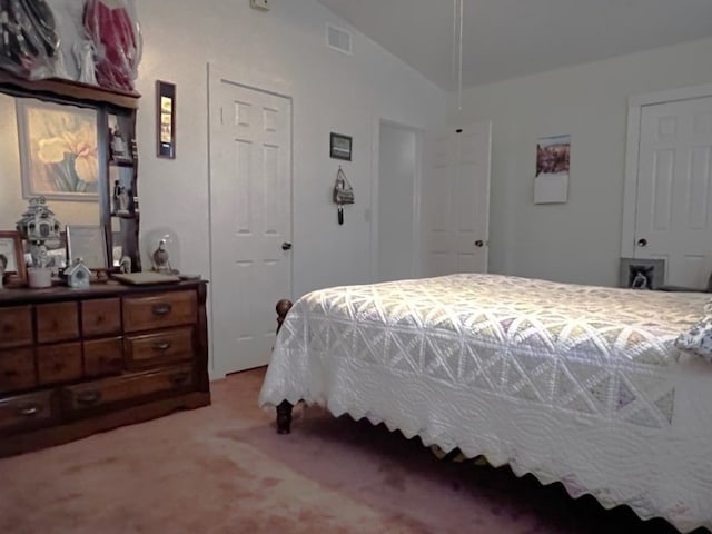 bedroom featuring light colored carpet and vaulted ceiling