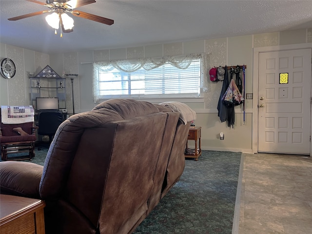 living room with ceiling fan and a textured ceiling