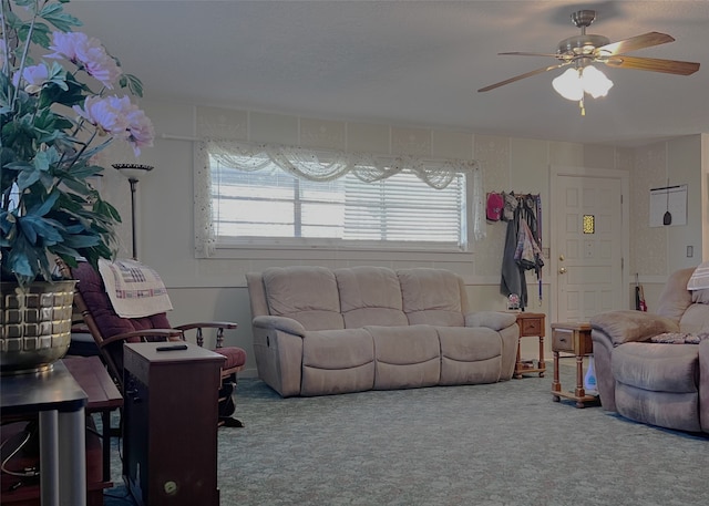 carpeted living room with ceiling fan