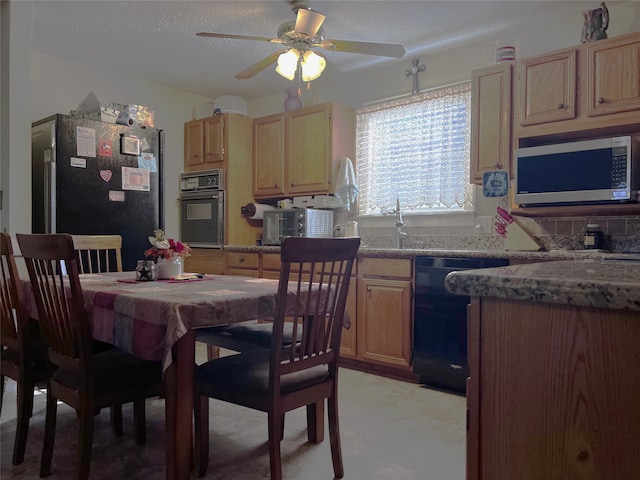 dining space with a textured ceiling, ceiling fan, and sink