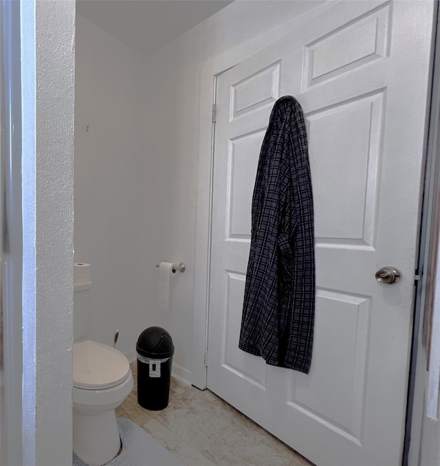 bathroom featuring tile patterned flooring and toilet