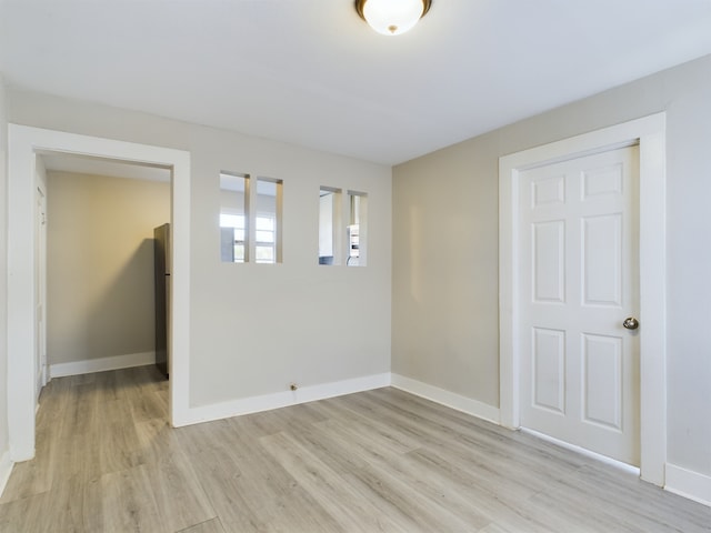 spare room featuring light hardwood / wood-style flooring