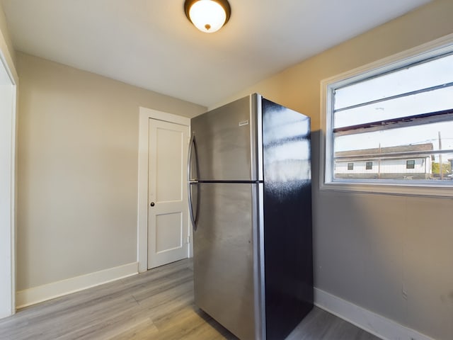 kitchen featuring light hardwood / wood-style floors and stainless steel refrigerator