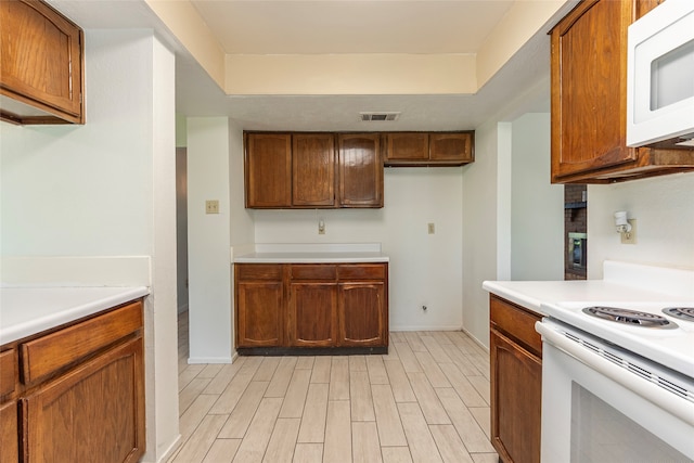 kitchen featuring light wood-type flooring and white appliances