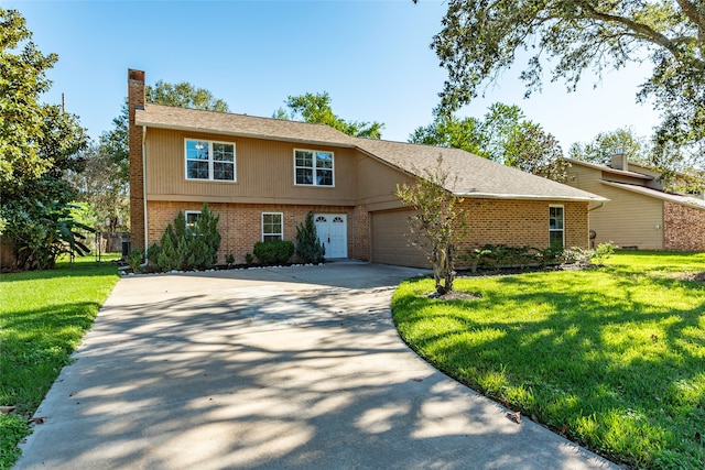 view of front of house with a front yard and a garage