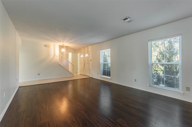 unfurnished room with dark wood-type flooring