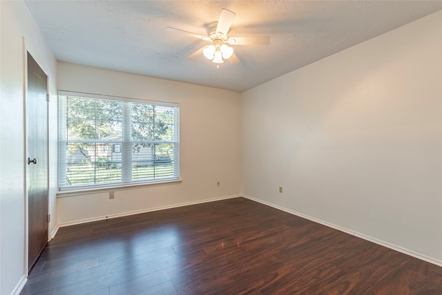 empty room with dark hardwood / wood-style floors and ceiling fan