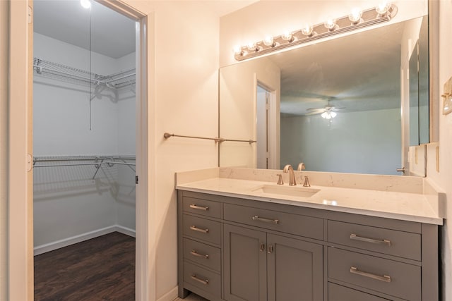 bathroom featuring vanity, hardwood / wood-style flooring, and ceiling fan