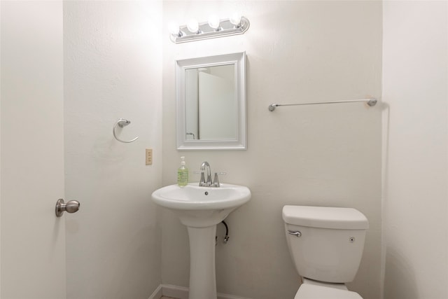 bathroom featuring toilet and sink